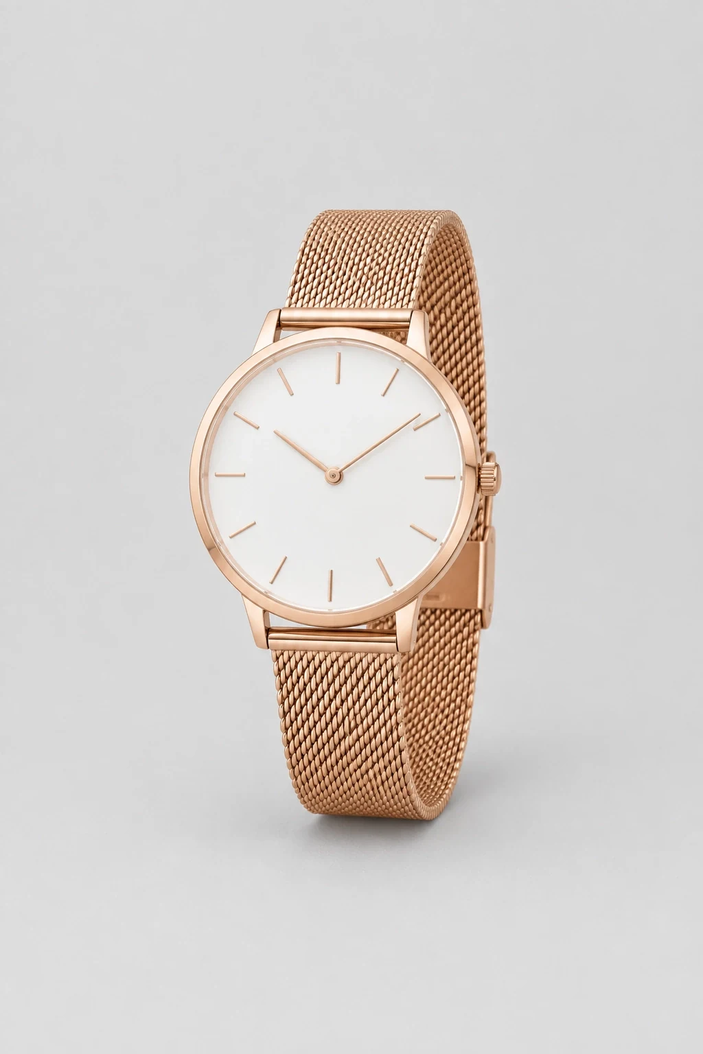 Minimalist rose gold tone watch on a fine mesh bracelet